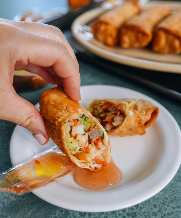 dipping egg roll in duck sauce