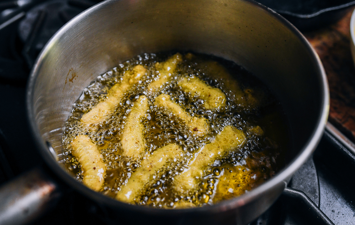 frying Sichuan peppercorn seasoned pork pieces