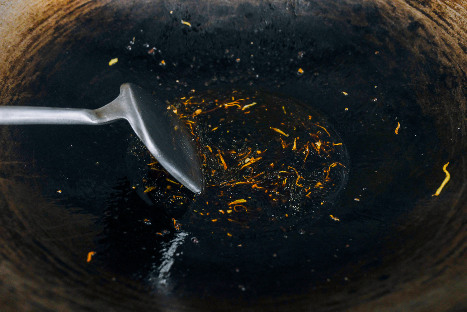 stirring sauce mixture for ginger beef using wok spatula