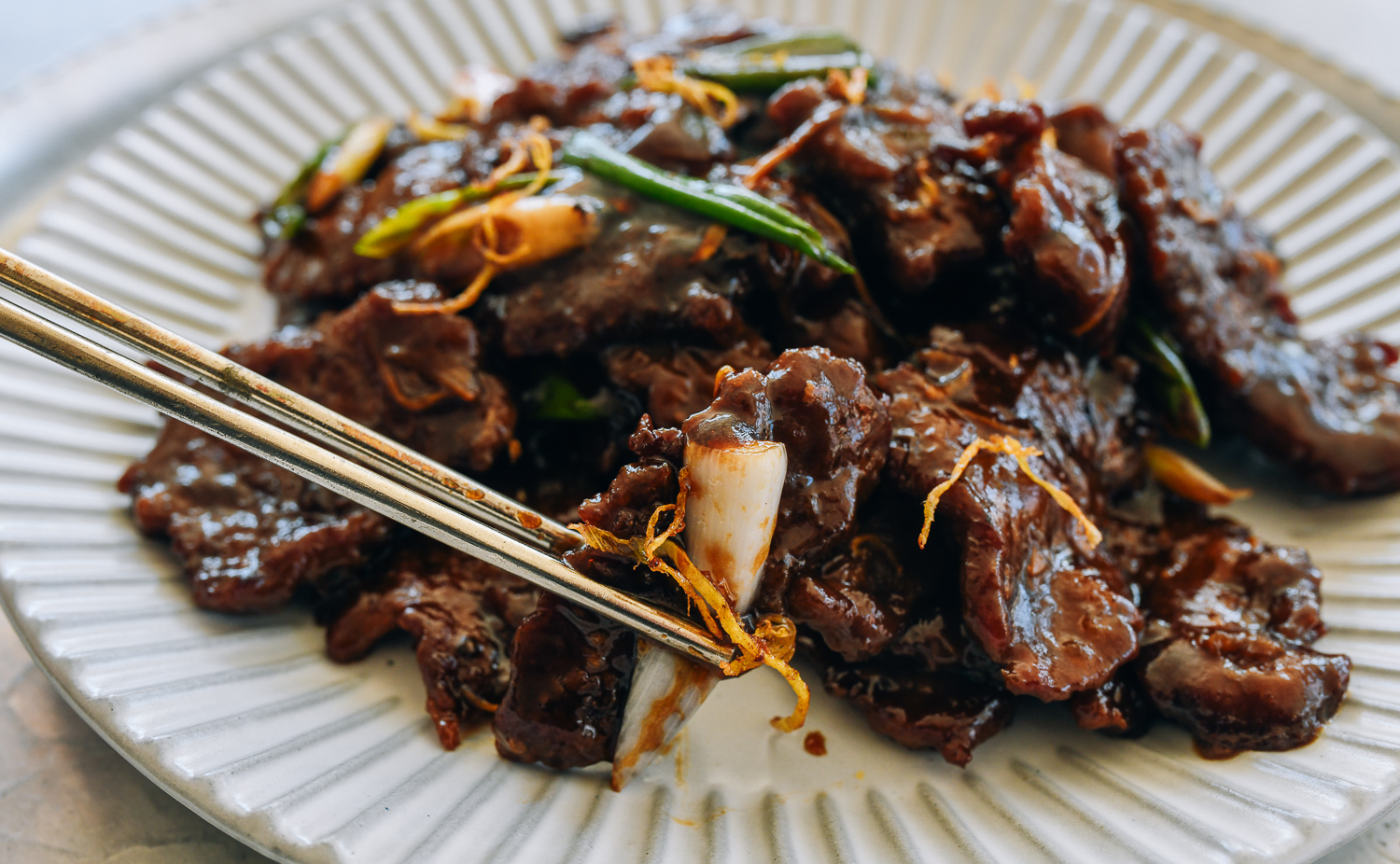 picking up a piece of ginger beef