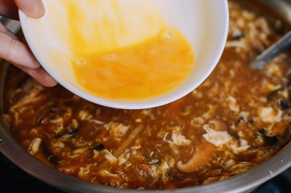 Adding egg to hot and sour soup, thewoksoflife.com